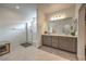Spacious bathroom featuring a glass-enclosed shower and double vanity at 617 Sylvan St, Henderson, NV 89002