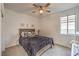 Cozy bedroom features a comfortable bed, soft carpet, and a window for natural light at 617 Sylvan St, Henderson, NV 89002