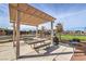 Community area featuring a shaded pergola, picnic tables, a grill, and common space at 617 Sylvan St, Henderson, NV 89002