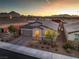 Charming single-story home with a two-car garage and desert landscaping at sunset at 617 Sylvan St, Henderson, NV 89002