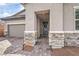 Inviting front entrance with stone accents and a covered porch at 617 Sylvan St, Henderson, NV 89002