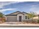 Charming single-story home featuring a two-car garage, stone accents, and landscaped front yard at 617 Sylvan St, Henderson, NV 89002