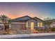 Well-lit exterior of a single-story home at dusk, highlighting the garage and front entrance at 617 Sylvan St, Henderson, NV 89002