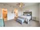 Spacious main bedroom with a ceiling fan, carpet flooring, and a plaid-patterned bedspread at 617 Sylvan St, Henderson, NV 89002