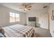 Bright main bedroom featuring a large window, modern dresser, and neutral carpet at 617 Sylvan St, Henderson, NV 89002