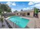 Inviting backyard showcasing a private pool, patio area, and lush landscaping, perfect for outdoor relaxation and entertainment at 6791 Greengrove Dr, Las Vegas, NV 89103