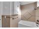 Bathroom with tiled shower and tub, vanity with upper cabinet, and sleek fixtures, offering a spa-like experience at 6791 Greengrove Dr, Las Vegas, NV 89103