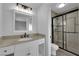 Nicely renovated bathroom with granite countertops, modern fixtures, and a glass-enclosed shower at 6791 Greengrove Dr, Las Vegas, NV 89103