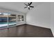 Sunlit bedroom offering dark tile floors, a ceiling fan, and sliding glass door to the backyard pool at 6791 Greengrove Dr, Las Vegas, NV 89103