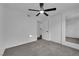 Simple bedroom with plush carpeting, neutral walls, closet space, and ceiling fan with light at 6791 Greengrove Dr, Las Vegas, NV 89103