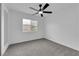 Bedroom features plush carpeting, neutral walls, closet space, and a large window with natural light at 6791 Greengrove Dr, Las Vegas, NV 89103