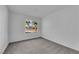Bright bedroom features plush carpeting, neutral walls, and a large window for natural light at 6791 Greengrove Dr, Las Vegas, NV 89103
