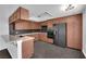 Modern kitchen featuring wood cabinets, granite countertops, and black stainless steel appliances at 6791 Greengrove Dr, Las Vegas, NV 89103