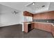 Open-concept kitchen offering sleek, dark tile floors, wooden cabinets, and granite countertops at 6791 Greengrove Dr, Las Vegas, NV 89103