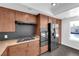Updated kitchen features modern appliances, granite counters, and wooden cabinets at 6791 Greengrove Dr, Las Vegas, NV 89103