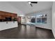 Spacious living room with tile floors and access to kitchen and sliding door to backyard pool at 6791 Greengrove Dr, Las Vegas, NV 89103