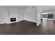 Bright living room with a cozy fireplace, tile flooring and sliding door to pool at 6791 Greengrove Dr, Las Vegas, NV 89103