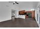 Bright living room features tile floors, adjacent to kitchen with dark wood cabinets at 6791 Greengrove Dr, Las Vegas, NV 89103