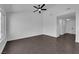 Cozy living room featuring a ceiling fan and large windows with dark tile floors at 6791 Greengrove Dr, Las Vegas, NV 89103