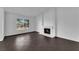Cozy living room boasts a charming fireplace, tile floors and abundant natural light at 6791 Greengrove Dr, Las Vegas, NV 89103