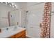 Bathroom with a single sink vanity and a shower-tub combination with white tile surround and a patterned shower curtain at 689 Bay View Dr # 1311, Boulder City, NV 89005