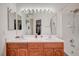 Bright bathroom featuring a double sink vanity, well-lit mirror, and a shower-tub combination with white tile surround at 689 Bay View Dr # 1311, Boulder City, NV 89005
