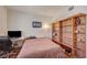 Bedroom featuring hardwood floors, natural light, a workspace, and a decorative wooden bookshelf at 689 Bay View Dr # 1311, Boulder City, NV 89005