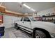 Well-lit garage space with shelving, overhead storage, and a truck parked inside at 689 Bay View Dr # 1311, Boulder City, NV 89005