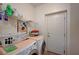 Functional laundry room with washer, dryer, storage shelves, and access door to the exterior at 689 Bay View Dr # 1311, Boulder City, NV 89005