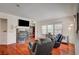 Relaxing living room boasts hardwood floors, a fireplace, and ample natural light from large windows at 689 Bay View Dr # 1311, Boulder City, NV 89005