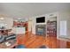 Bright living room featuring hardwood floors, a fireplace, and an open layout to the kitchen at 689 Bay View Dr # 1311, Boulder City, NV 89005