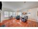 Bright living room featuring hardwood floors and lots of natural light from large windows with blinds at 689 Bay View Dr # 1311, Boulder City, NV 89005