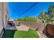 Private patio area with outdoor seating and artificial turf, surrounded by a block wall for privacy at 689 Bay View Dr # 1311, Boulder City, NV 89005