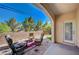 This covered patio features comfortable seating, a paver floor, and a view of the fenced yard at 689 Bay View Dr # 1311, Boulder City, NV 89005