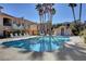 Community pool surrounded by lounge chairs and tropical palm trees for a resort-style experience at 689 Bay View Dr # 1311, Boulder City, NV 89005