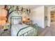 Cozy bedroom with a monkey-themed wall decal, a green metal bed frame and neutral carpeting at 6928 Wrightshire St # 19, Las Vegas, NV 89166