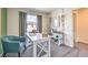 Comfortable home office with a white desk, teal chair, large window, and stylish decor for a productive workspace at 6928 Wrightshire St # 19, Las Vegas, NV 89166