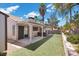 Spacious backyard with artificial turf and covered patio at 6997 Ray Charles Ln, Las Vegas, NV 89119
