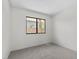 The bedroom offers neutral walls, plush carpet, and a window framing serene outdoor views at 6997 Ray Charles Ln, Las Vegas, NV 89119