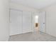 Bright bedroom with plush carpeting, closet with sliding doors, and a doorway leading to an en-suite bathroom at 6997 Ray Charles Ln, Las Vegas, NV 89119