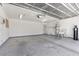 Spacious garage with concrete floor, utility sink, and water softener at 6997 Ray Charles Ln, Las Vegas, NV 89119