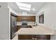 Kitchen featuring stainless steel appliances, granite countertops, and wooden cabinets at 6997 Ray Charles Ln, Las Vegas, NV 89119