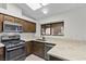 The kitchen boasts stainless steel appliances, granite countertops, and ample cabinet space for storage at 6997 Ray Charles Ln, Las Vegas, NV 89119