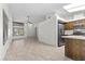 Open-concept living room with tile floors, vaulted ceilings, and an adjacent kitchen at 6997 Ray Charles Ln, Las Vegas, NV 89119