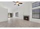 Living room with fireplace, ceiling fan, and tile flooring at 6997 Ray Charles Ln, Las Vegas, NV 89119