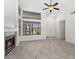 Light-filled living room with fireplace, tile flooring, and large windows at 6997 Ray Charles Ln, Las Vegas, NV 89119