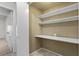 A walk-in storage space with tiled floors, shelving, and white walls at 6997 Ray Charles Ln, Las Vegas, NV 89119