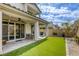 An inviting outdoor patio with stylish seating and easy access to a well-manicured artificial grass backyard at 7061 Tilligerry St, North Las Vegas, NV 89084