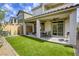 Charming backyard featuring a well-manicured lawn, covered patio and outdoor seating, great for relaxation and entertainment at 7061 Tilligerry St, North Las Vegas, NV 89084