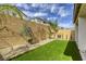 A well maintained backyard featuring low maintenance landscaping, greenery and privacy fence offers a serene outdoor space at 7061 Tilligerry St, North Las Vegas, NV 89084